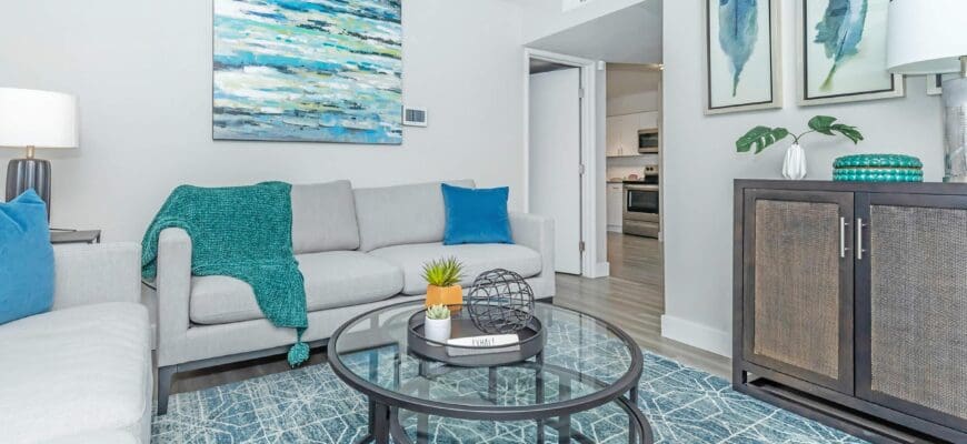 et-friendly-apartments-in-phoenix-az-tides-on-71st-living-room-with-a-ceiling-fan-wood-style-floors-and-a-glass-coffee-table-